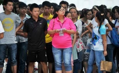 6月7日，雅安天全中學的呂莎莎老師(中)在考場外等待自己的學生出來。
